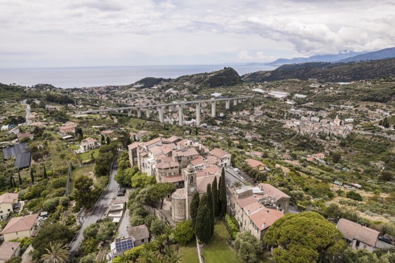 Aerial view of the village of Sasso with the bell tower, the viaduct, the hills and the coast towards the sea