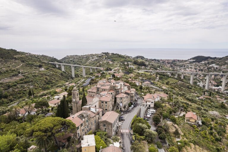Aerial view of the village of Sasso with the motorway viaduct, the hills and the sea on the horizon